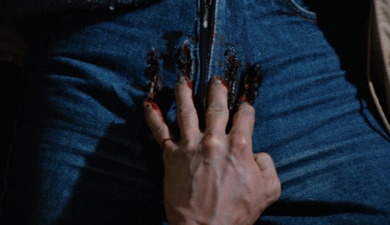 A bloody hand grasps in Pieces (1982).