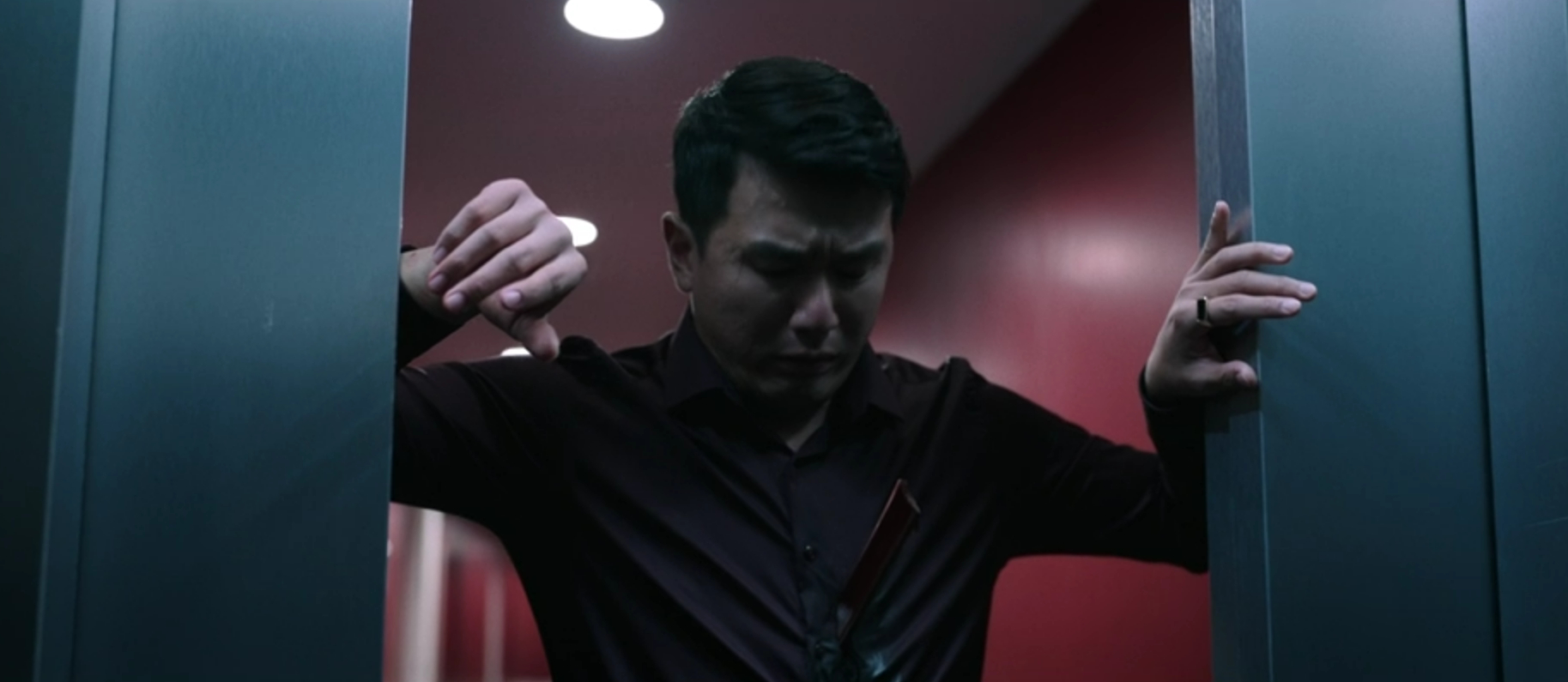 David looks at the paper-cutter blade sticking out of his torso in M3GAN: Unrated (2023).