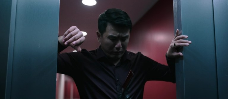 David looks at the paper-cutter blade sticking out of his torso in M3GAN: Unrated (2023).