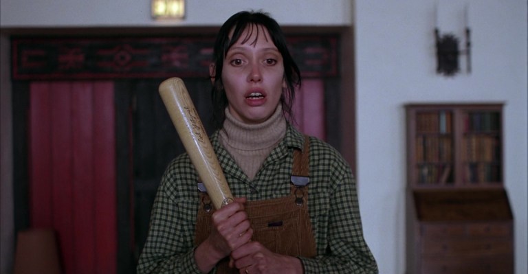 Shelley Duvall clutches a baseball bat in The Shining (1980).