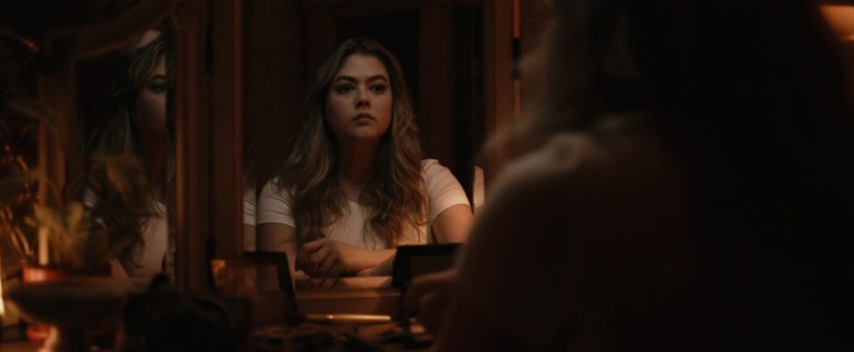 Eden prepares to party in You're Killing Me (2023).