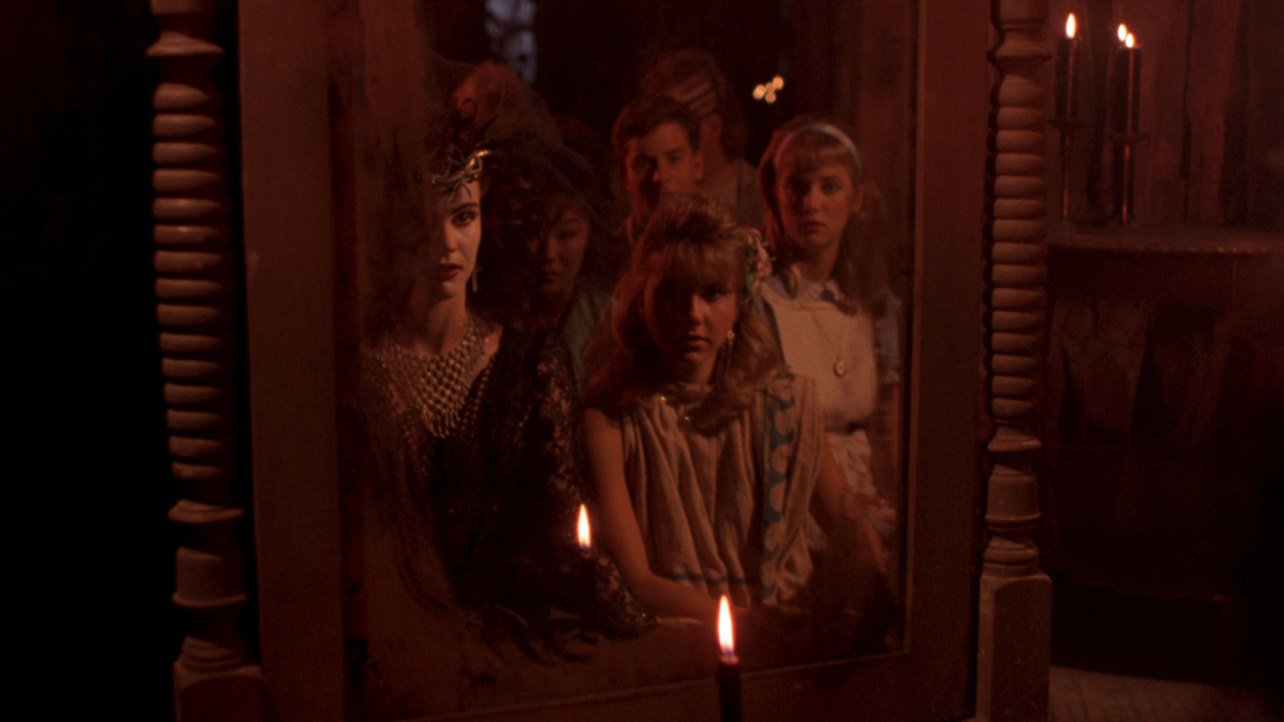 Partiers stare into a mirror in Night of the Demons (1988).
