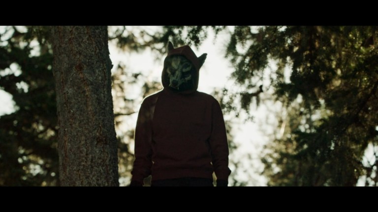The Wolf stands by a tree in Prey for the Bride (2024).
