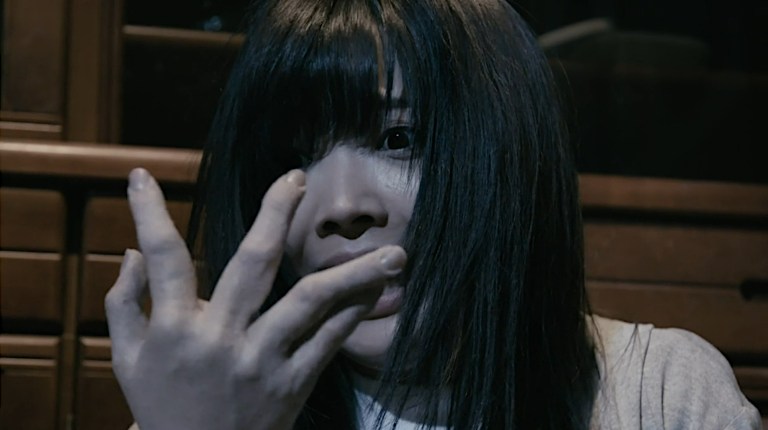A woman's hand goes floppy in Vampire Clay (2017).