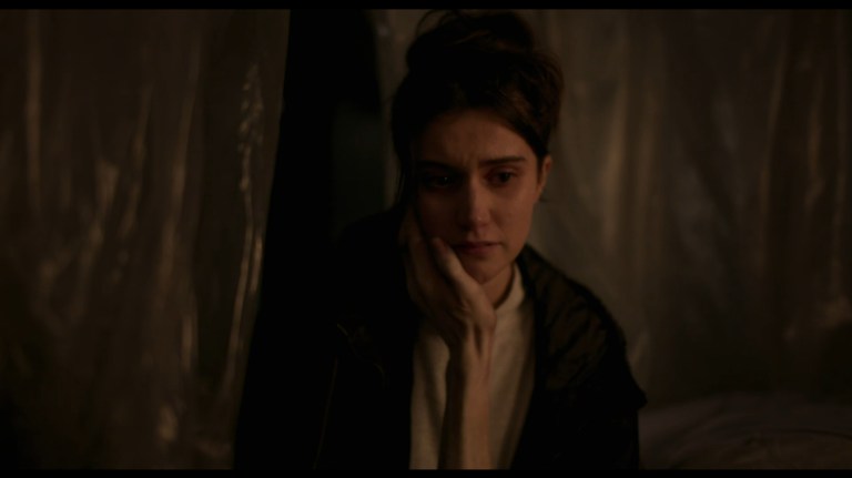 Anna has an emaciated hand caress her face in All You Need is Death (2023).