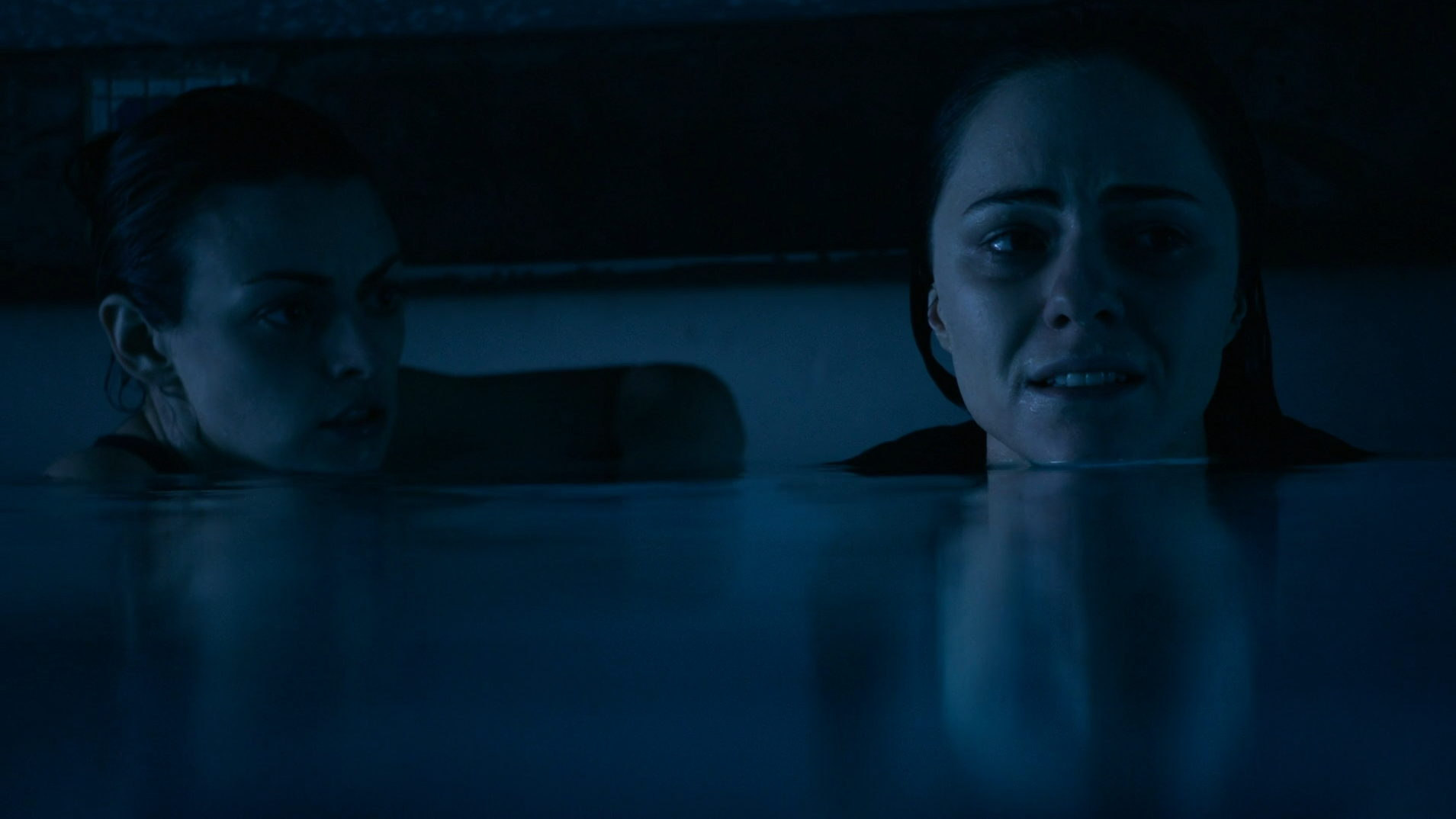 Two sisters trapped under a pool cover in 12 Feet Deep (2017).