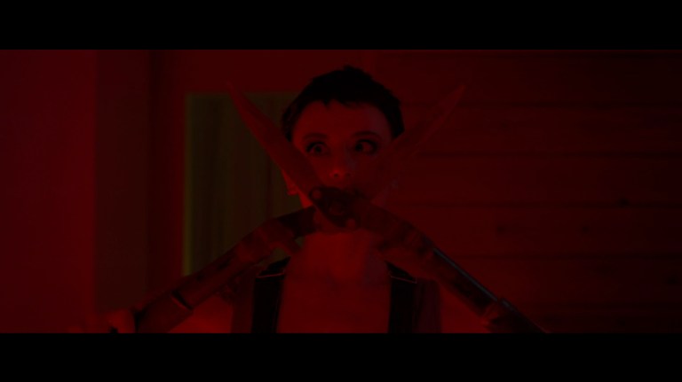 Bowie holds a pair of hedge shears in Faceless After Dark (2023).