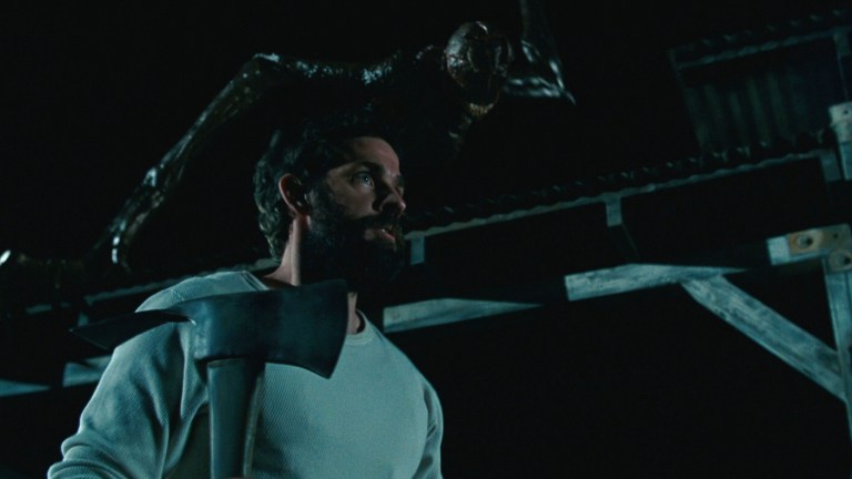 Lee tenses as a creature prepares to attack in A Quiet Place (2018).