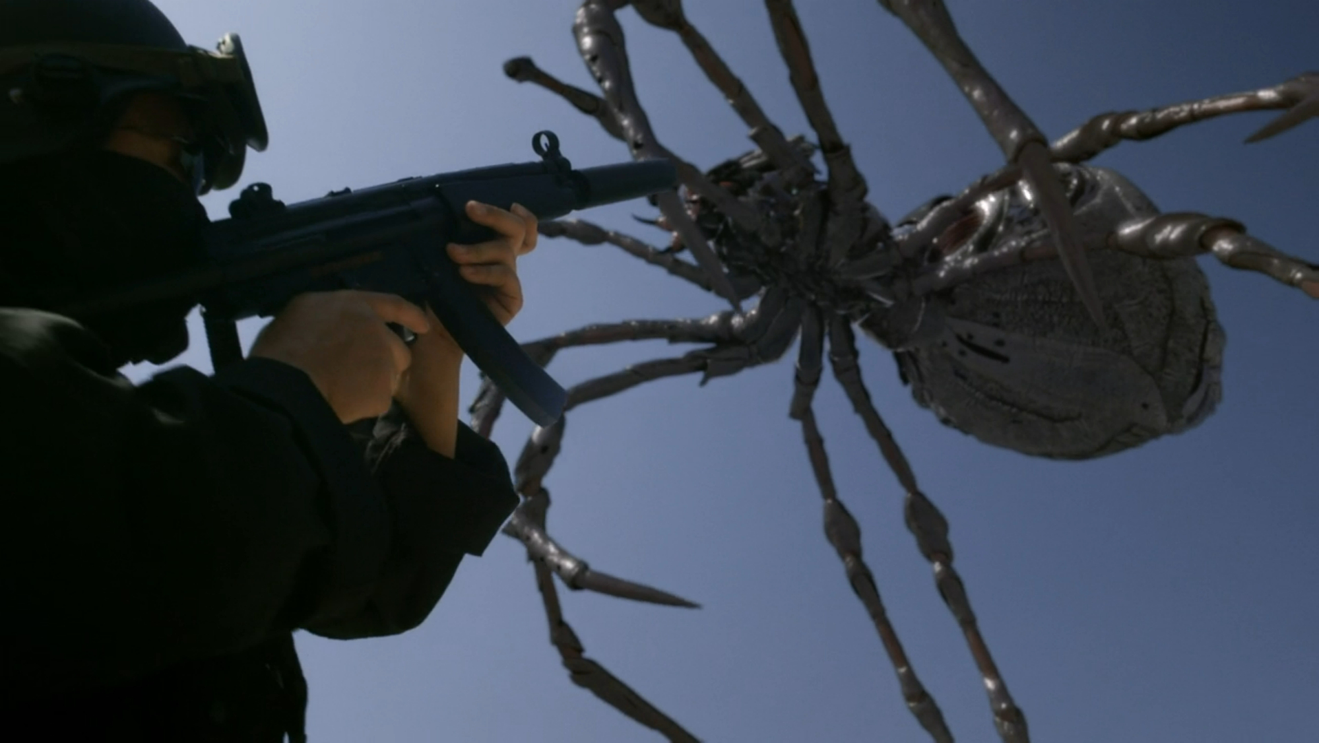 A large spider leaps over a person with a gun in Big Ass Spider (2013).