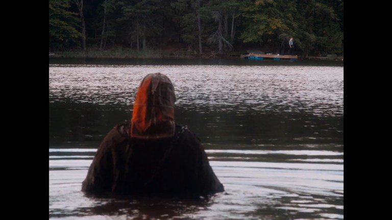 Johnny walks into a lake in In a Violent Nature (2024).