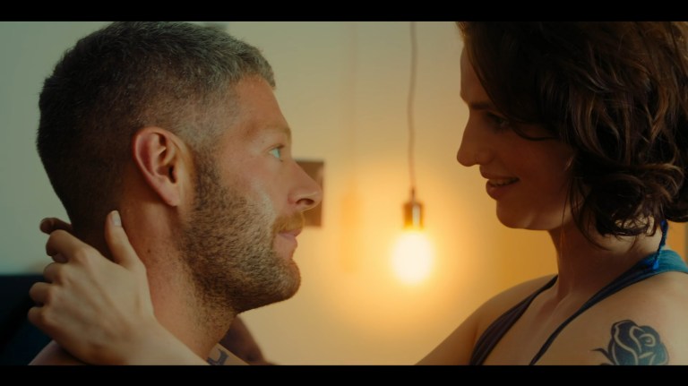 Axel and Dakota look at each other in Kill Your Lover (2023).