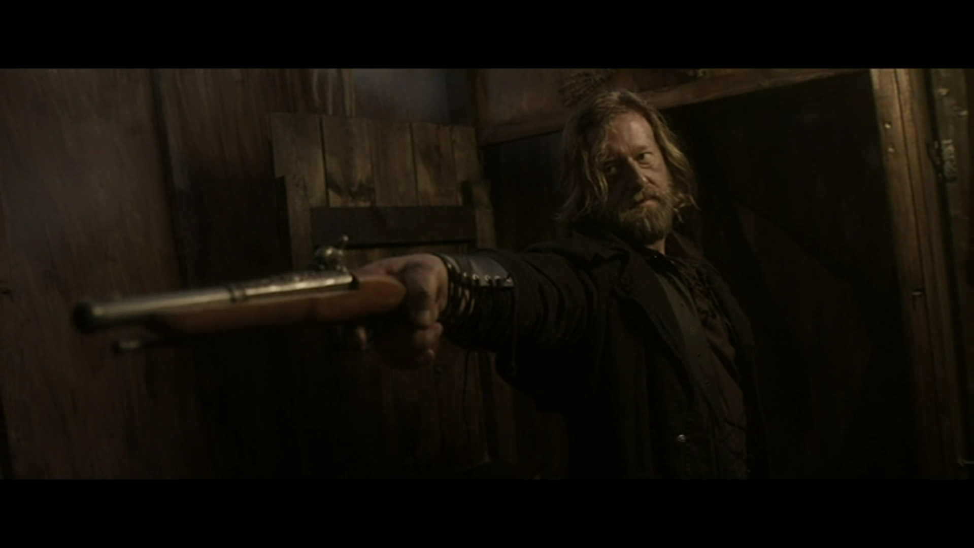 Jacob holds a gun in Ship of the Damned (2024).