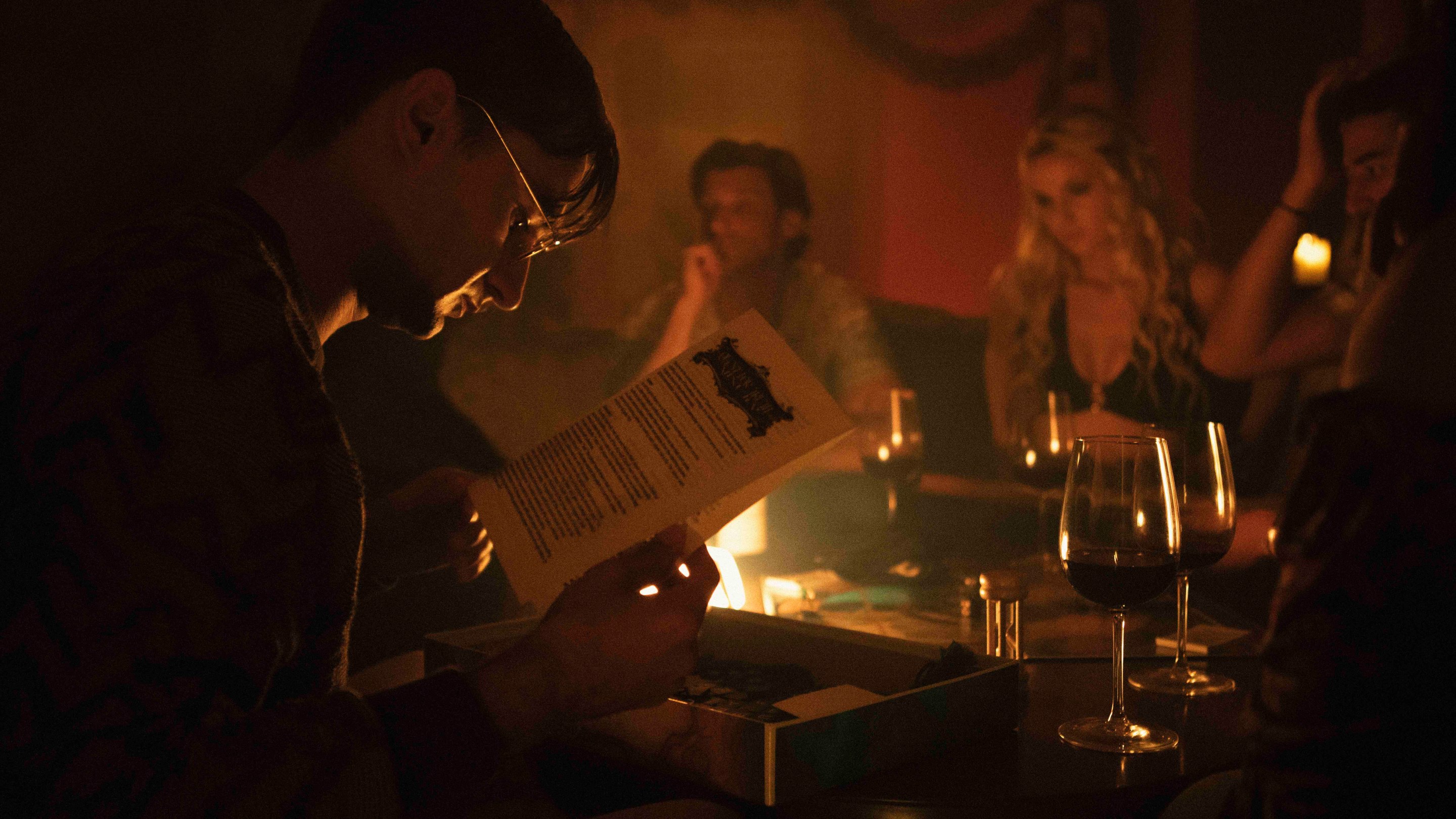 Stanley reads the instructions for the board game in Stupid Games (2024).