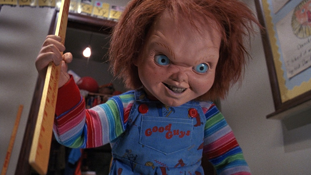 Chucky menacingly holds a yard stick in Child's Play 2 (1990).