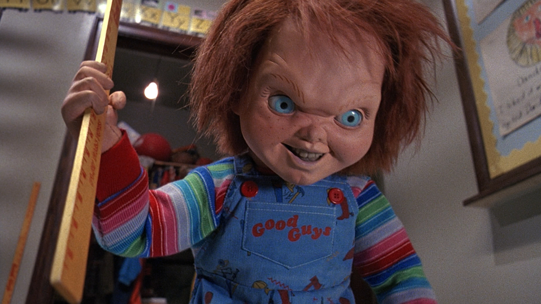 Chucky menacingly holds a yard stick in Child's Play 2 (1990).