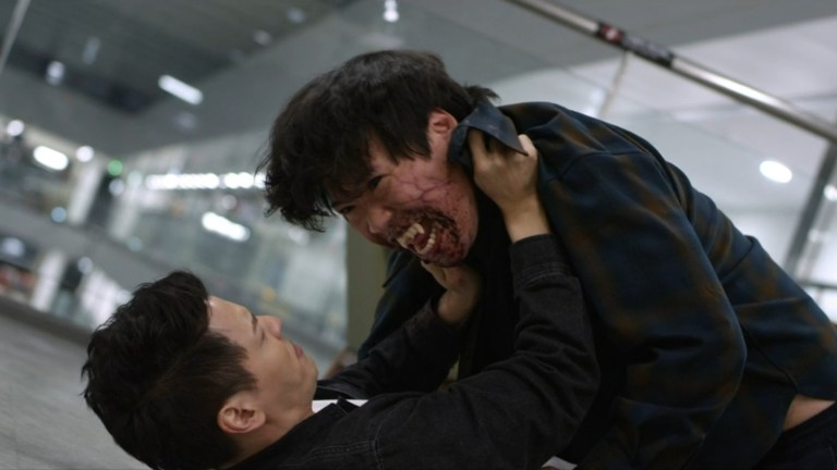 A zombie attacks a man in Gangnam Zombie (2023).