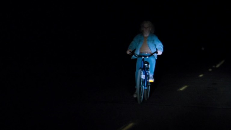 A creepy bike rider in In the Mouth of Madness (1994).