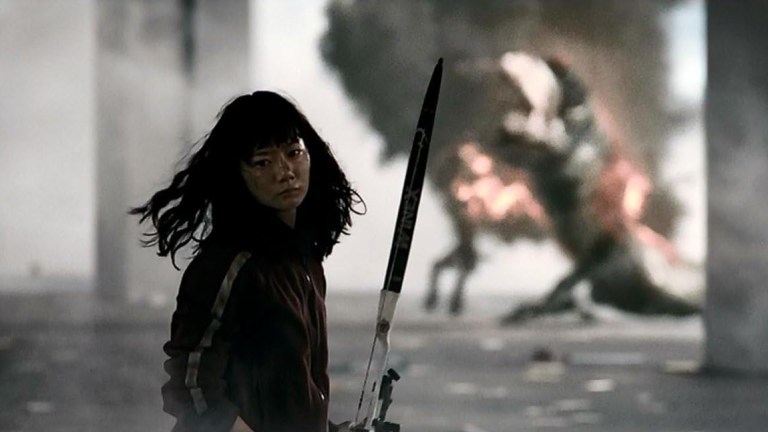 Nam-joo walks away from a burning monster in The Host (2006).