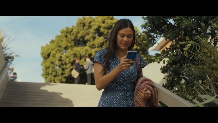 Iris can't believe what she's seeing on her phone in Afraid (2024).