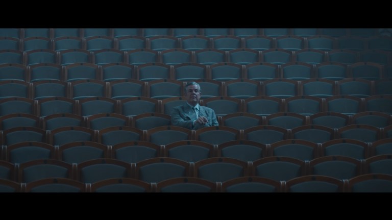 Roeg sits alone in a theater in The Crow (2024).