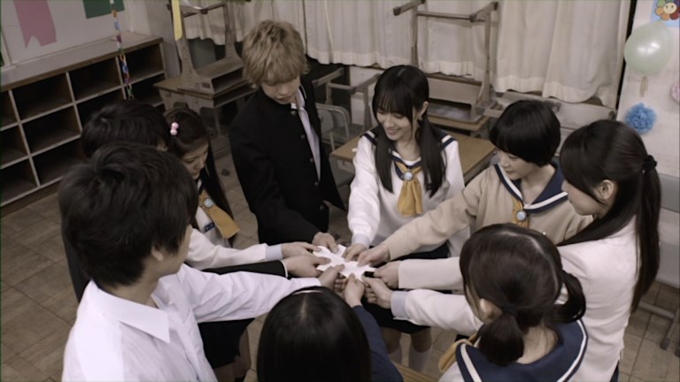 Friends grip a paper doll in Corpse Party.