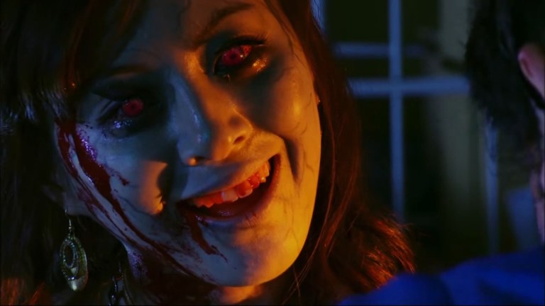 A female zombie smiles in Zombrex: Dead Rising Sun (2010).