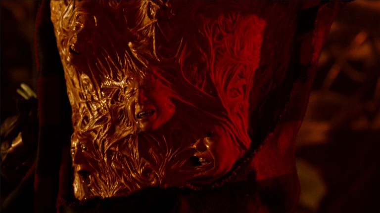 A closeup of Freddy's torso reveals the faces of people he's killed in A Nightmare on Elm Street 3: Dream Warriors (1987).