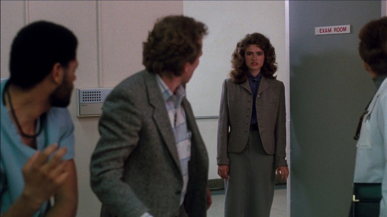 Nancy walks into a room while everyone looks at her in A Nightmare on Elm Street 3: Dream Warriors (1987).