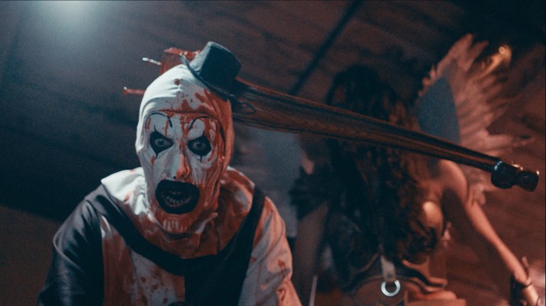 Art the Clown has a weapon embedded in his head in Terrifier 2 (2022).