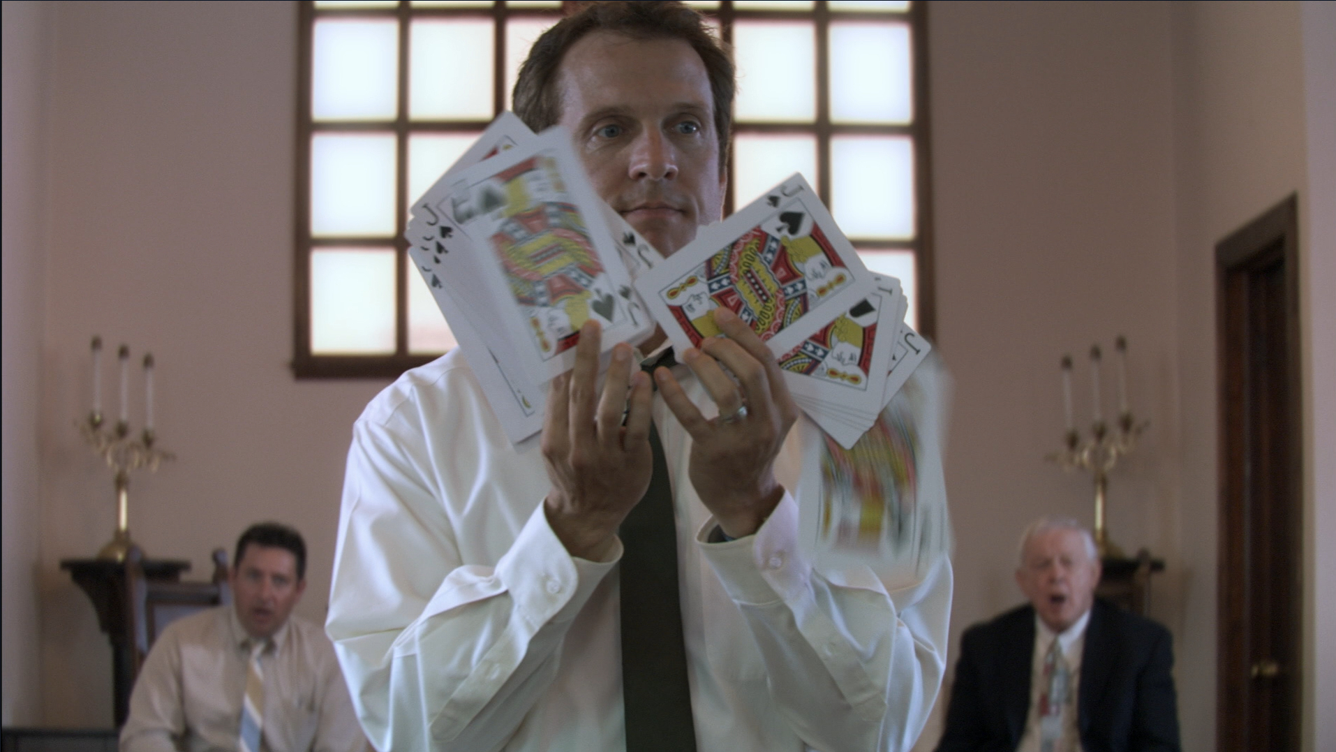 Cotton Marcus does a card trick in The Last Exorcism (2010).