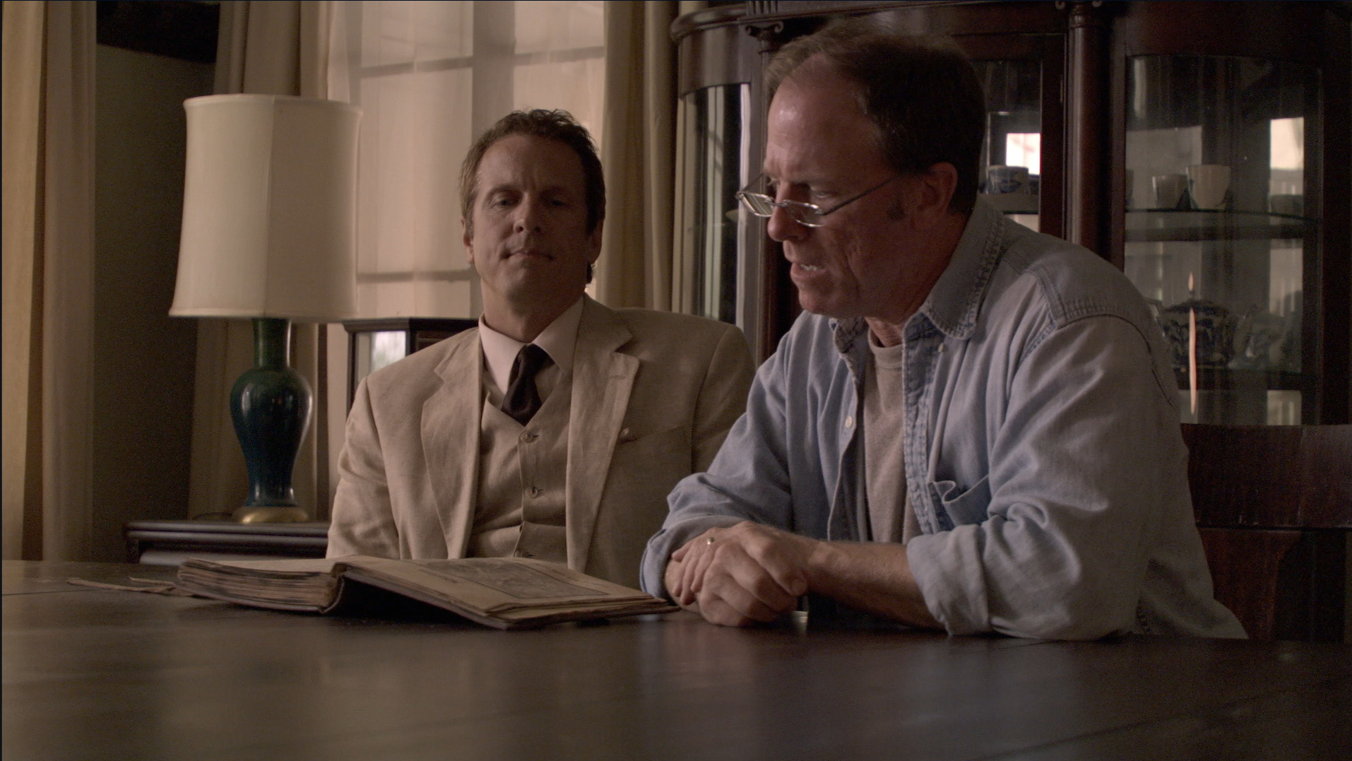 Cotton Marcus watches as Louis tries to read Latin in The Last Exorcism (2010).