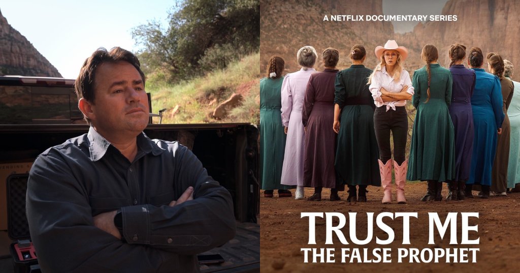 A man with arms crossed leans against the tailgate of a pickup truck on a red dirt road with canyon cliffs and vegetation in the background.