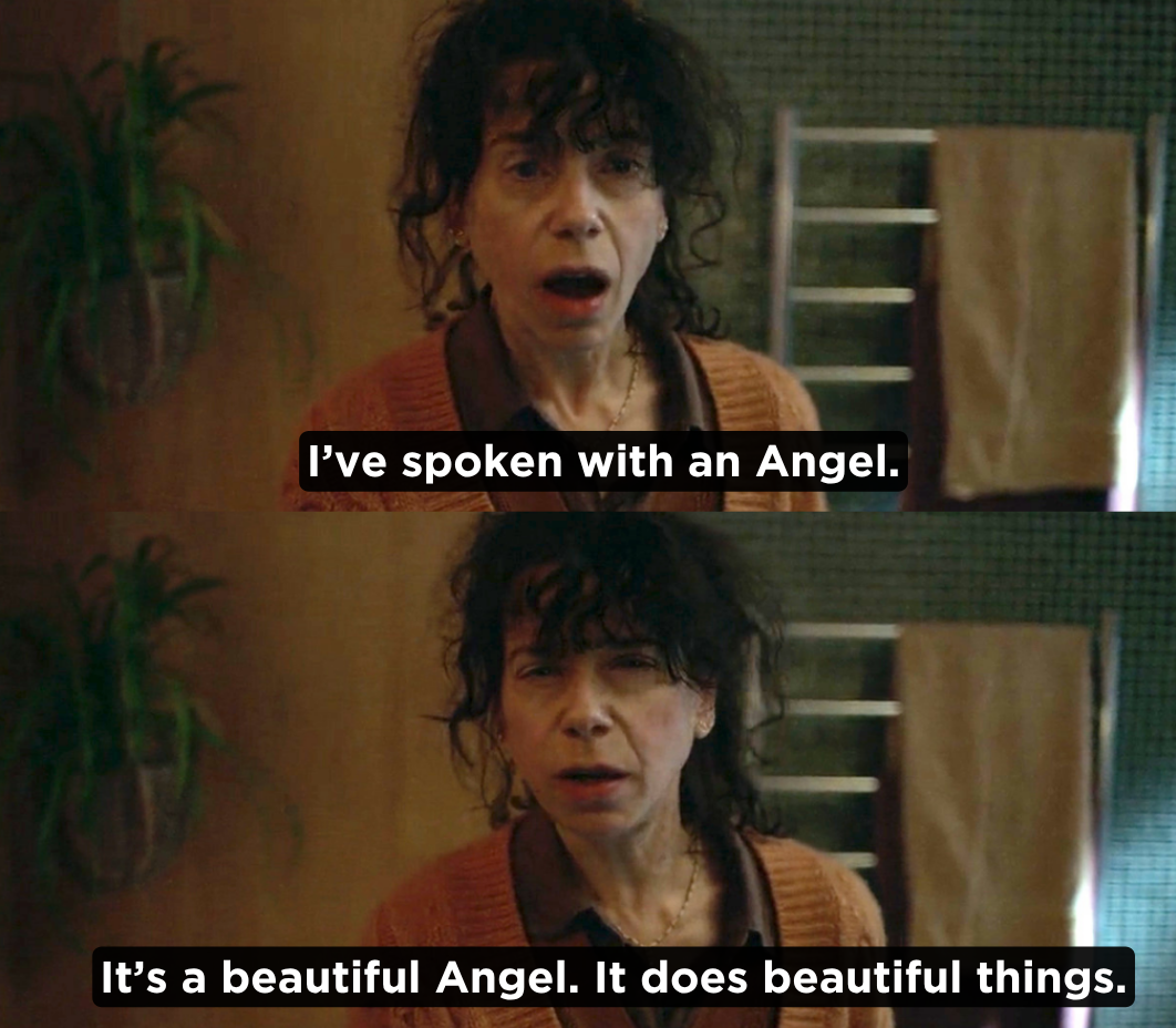 Two-panel still of a curly-haired woman in an orange cardigan with subtitles reading 'I've spoken with an Angel' and 'It's a beautiful Angel. It does beautiful things.'